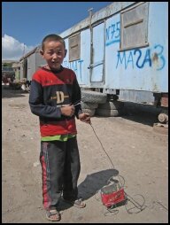Boy at the border, with a handmade toy